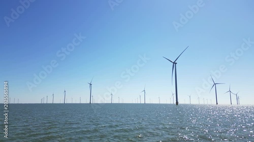 Green energy, wind turbines produce energy in the North Sea, wind farm power plant view from height, alternative energy sources.