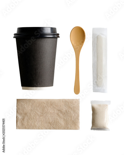 Black paper coffee cup with wooden stirrer and sugar packets isolated on transparent background flat lay composition for cafe shop branding and takeaway beverage service marketing product