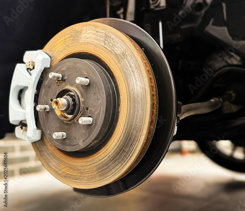 Fotografie Car ventilated front brake disc with caliper