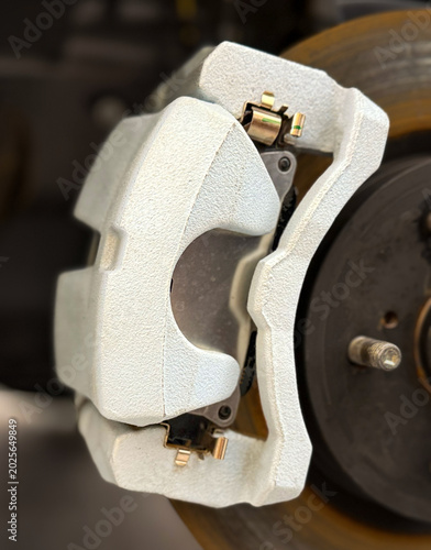 Fotografie Car ventilated front brake disc with caliper
