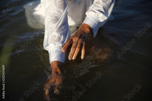 African Woman Washing Hands in a Lake
African Female Cleaning Hands in Natural Water
Woman Washing Hands Outdoors by Lake
African Woman in Nature Near Water