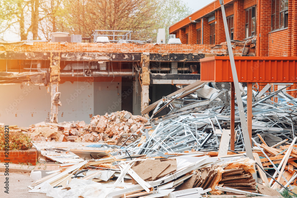 Obraz premium Construction site shows debris and materials after building demolition near a brick building