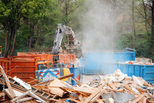 Принти на полотні Construction site with heavy machinery working on debris removal in a city area