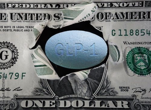 GLP-1 pill in a torn dollar bill