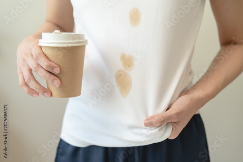Billede på lærred Clothes stain dirty from food concept, people get a coffee drop split from glass on the t-shirt