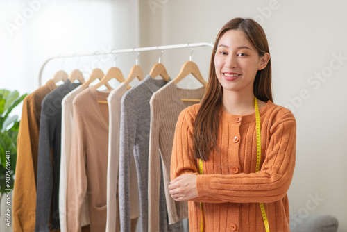Fotografie Young small business woman prepare used clothes to sell on internet