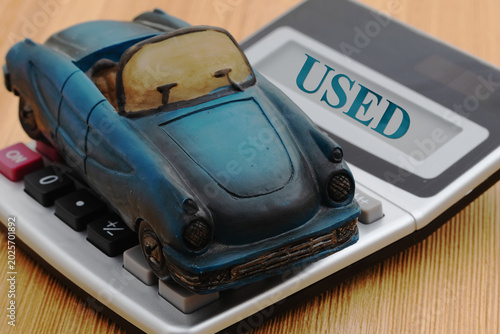Tableau sur toile Used text with a car on calculator on wood desk for buying a used car