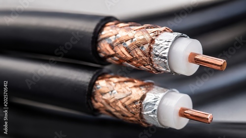 Close-up of coaxial cable with copper conductor and braided shielding for telecommunications and signal transmission, network infrastructure, and communication systems concept.