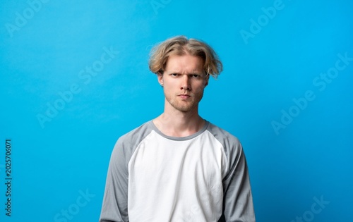 Картината върху платно Frustrated young man looking stressed, showing irritation and negative expressio