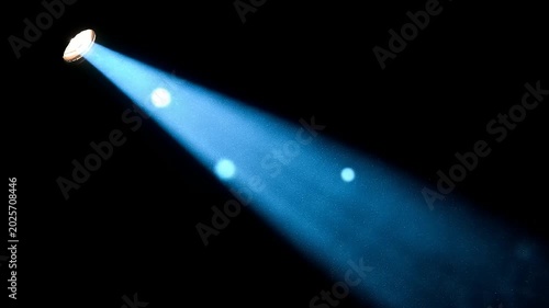Bright blue spotlight beam against black background conceptual design