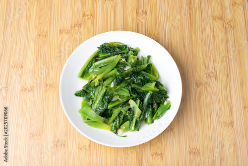 The stir-fried spinach leaves on the plate