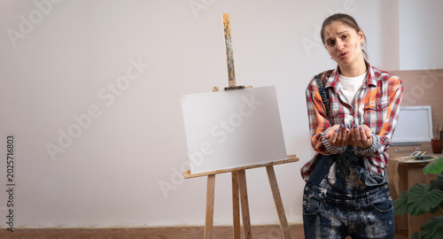Cuadro en lienzo Hopeful female artist holding open palms together in begging, pleading, or asking for help concept