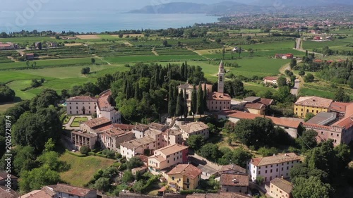 High angle view of the religious building and traditional piazza in Cola di Lazise Verona province