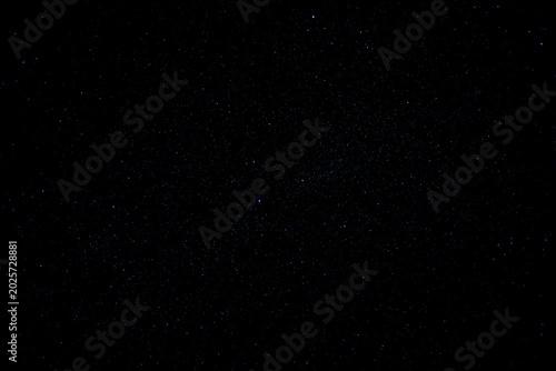 Fotografi Dark night sky filled with countless glowing stars and distant constellations