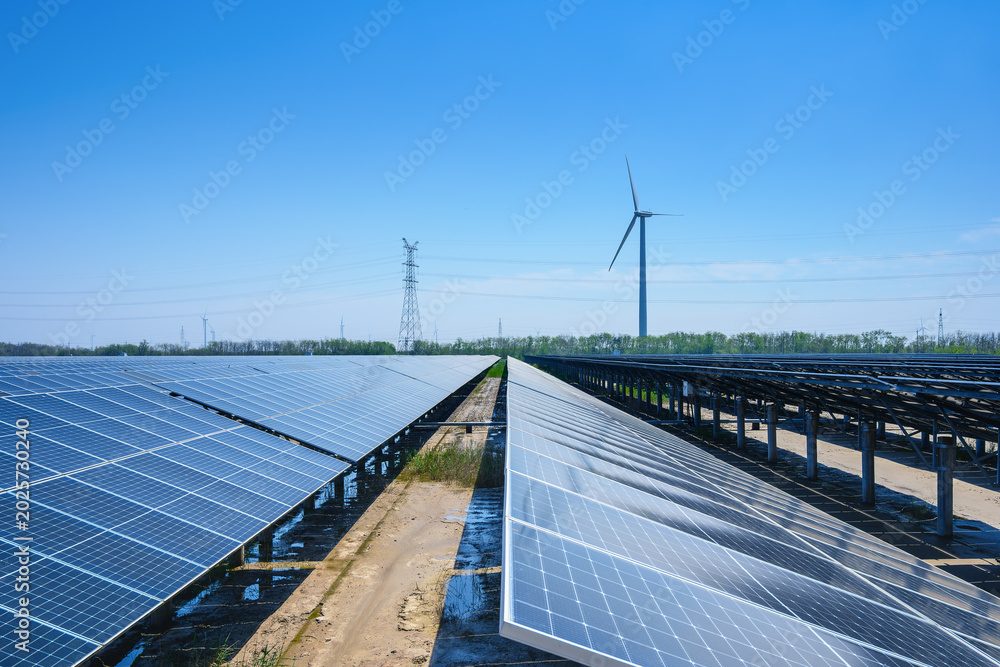 Fototapeta premium Coastal New Energy Base with Solar Panels and Wind Turbines