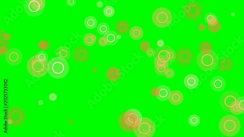 Abstract circles in varying shades of orange and yellow float across a vibrant green background, creating a dynamic and playful visual effect.