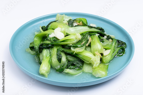 The stir-fried vegetables with green leaf lettuce on the plate