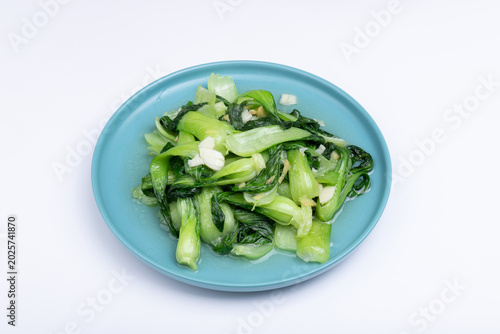 The stir-fried vegetables with green leaf lettuce on the plate