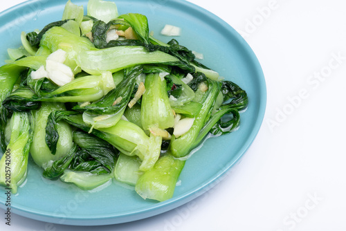 The stir-fried vegetables with green leaf lettuce on the plate