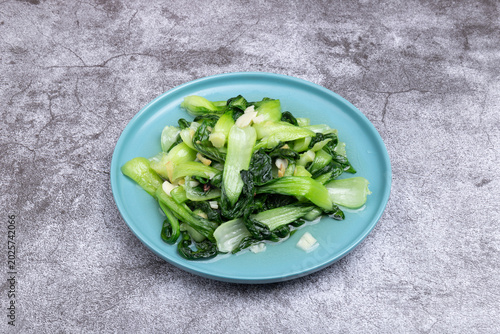 The stir-fried vegetables with green leaf lettuce on the plate