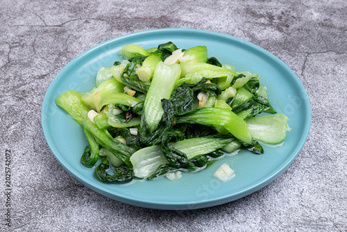 The stir-fried vegetables with green leaf lettuce on the plate