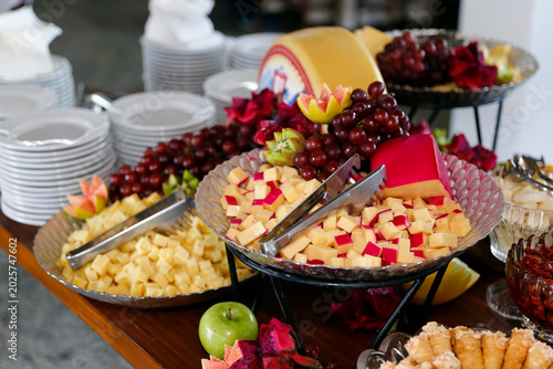 Buffet Table with Assorted Cheese Board Fruits and Metallic Stands for Hotel Events