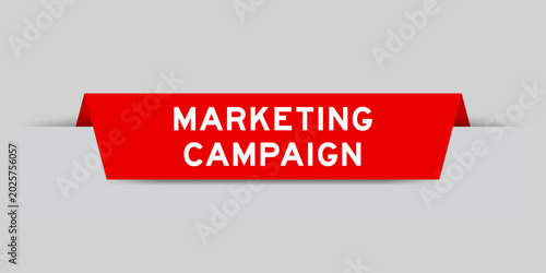 Red color inserted label with word marketing campaign on gray background