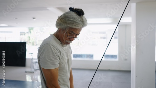 Schilderij op canvas Senior man concentrating during workout, embracing active lifestyle and health