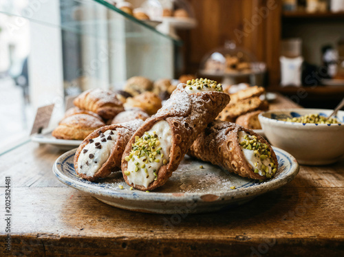 Traditional sicilian cannoli pastry filled with ricotta cheese at an italian bakery