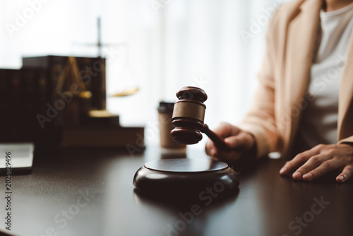 Принти на полотні Judge or lawyer holding a wooden gavel while striking down a verdict or making a