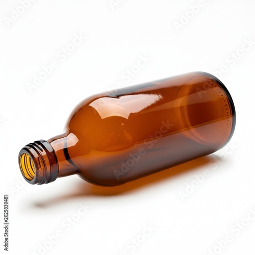 Amber glass bottle laying on white surface pharmaceutical packaging empty container product shot