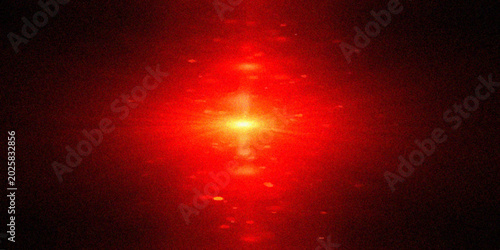 Tableau sur toile A dramatic abstract background featuring a vibrant red laser beam bursting with an intense central glow and scattered horizontal light flares over a dark, grainy texture