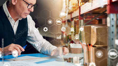 Konstfotografi Logistics manager works with data in a warehouse during the day