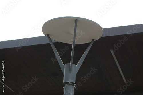Modern outdoor lamp post with a circular shade and sleek metal design
