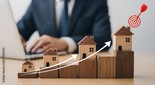 Real estate investment growth concept wooden houses stacked with upward trend and businessman