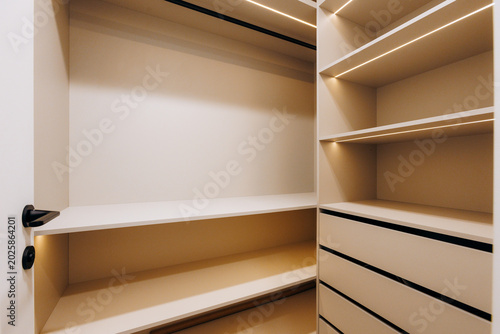 Neutral minimalist modular closet prepared for showroom shoot