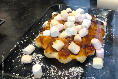Принти на полотні Traditional Belgian Liege waffle topped with caramelised sugar, mini marshmallow