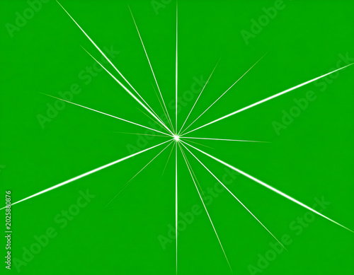 White starburst light flare on green screen.