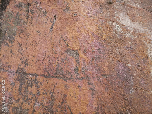 Macro shot of rough orange mountain rock texture with natural patterns