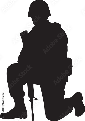Silhouette of a soldier kneeling with a rifle