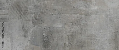 Obraz  z motywem Concrete background features a dark grey weathered cement wall surface with fine rustic linear textures