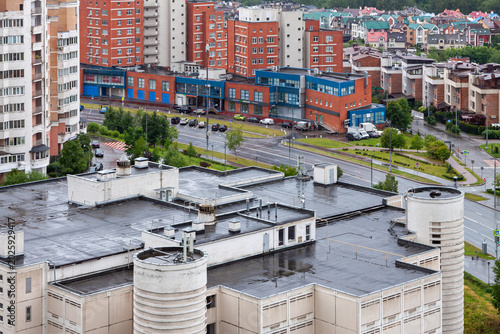 Urban residential district with apartment buildings and wet rooftops after rain