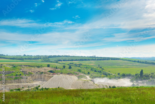 Open Pit Limestone Quarry Mining Site with White Dust Clouds, Industrial Resource Extraction Excavation Area