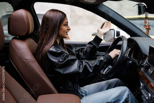 Canvas Print Beautiful woman beep in the car in panic with closed eyes while driving on high speed