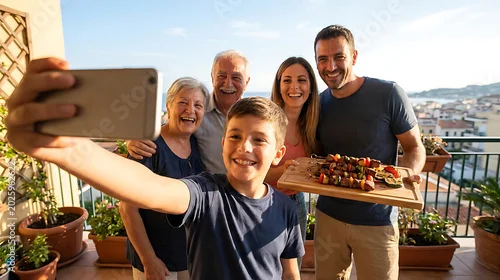 Fototapeta Multi-generational family taking a selfie with food on a balcony, group photo