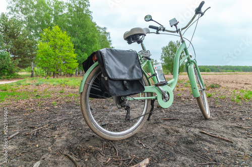 Photos Bicycle parked with pannier bag on rural dirt trail