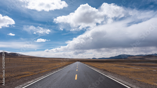 Photography road in the desert,Scenery of the uninhabited area of Tibet, blue sky and white