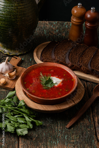 Traditional Ukrainian borscht soup with sour cream and spoon top view