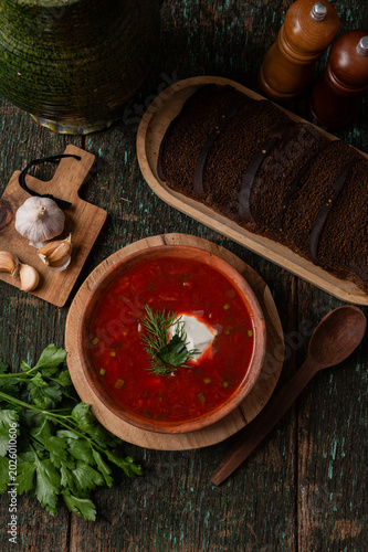 Traditional Ukrainian borscht soup with sour cream and spoon top view
