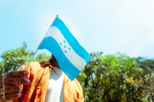 Photos Person holding honduran flag celebrating national pride